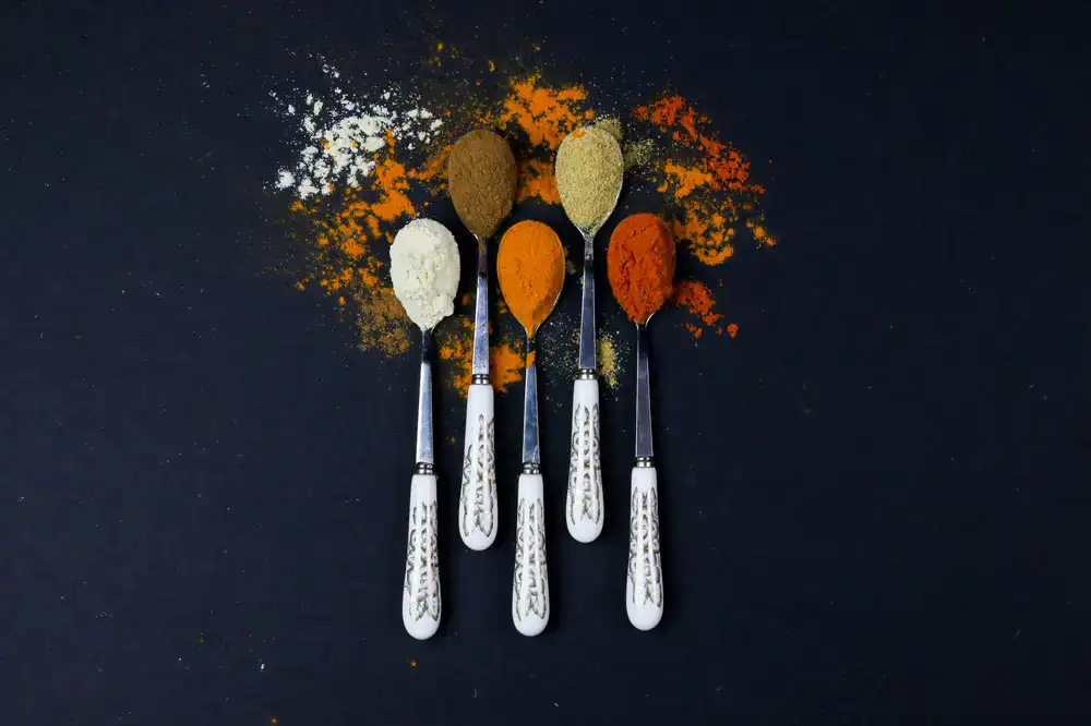 Vibrant yellow curry powder in a scoop