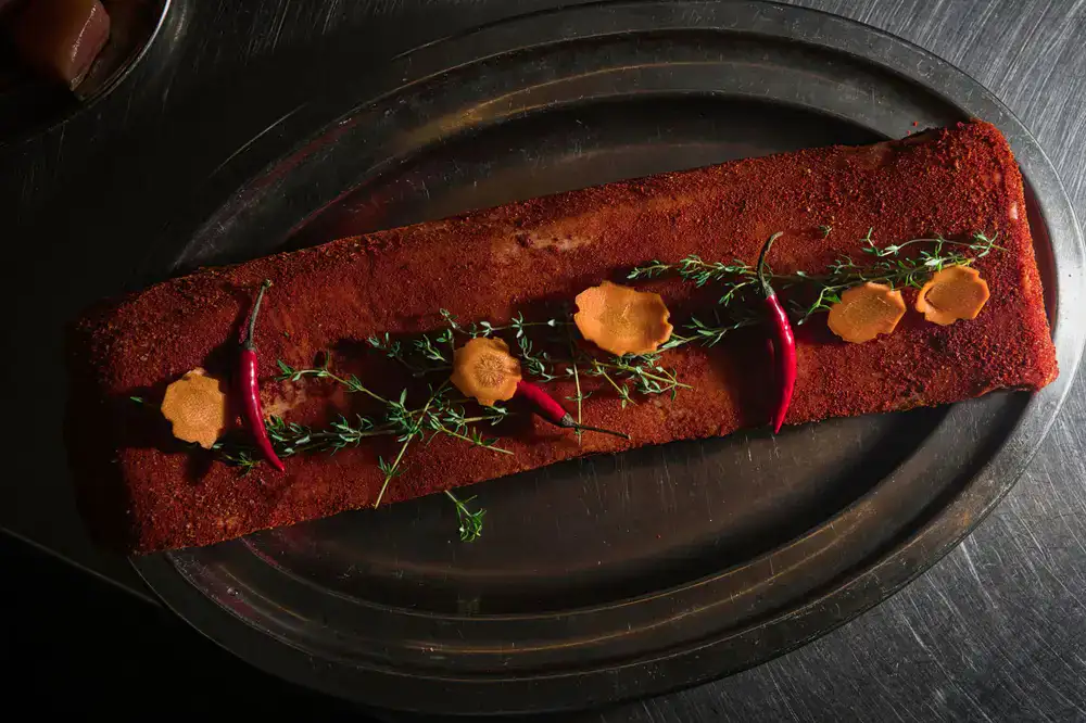 Dark coarse spice rub in a small dish