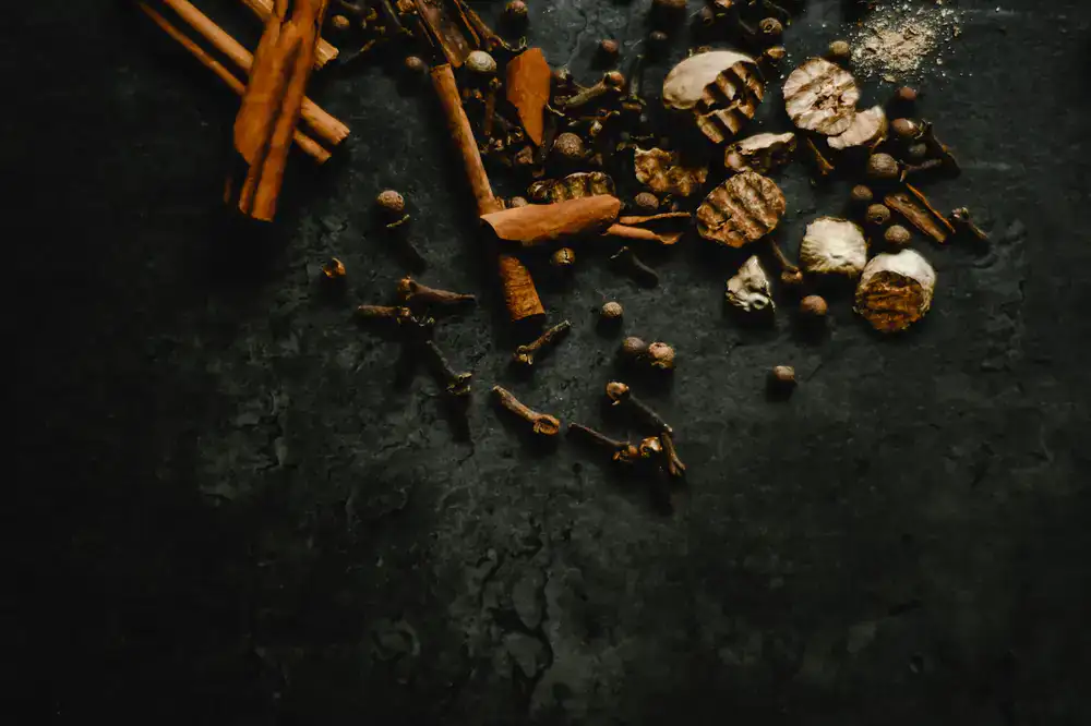 Aromatic spices being stirred into a warm pan