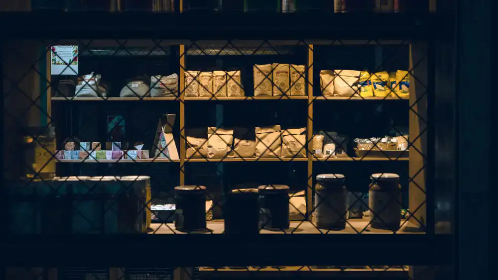 Warmly lit spice shop interior with jars lining the shelves